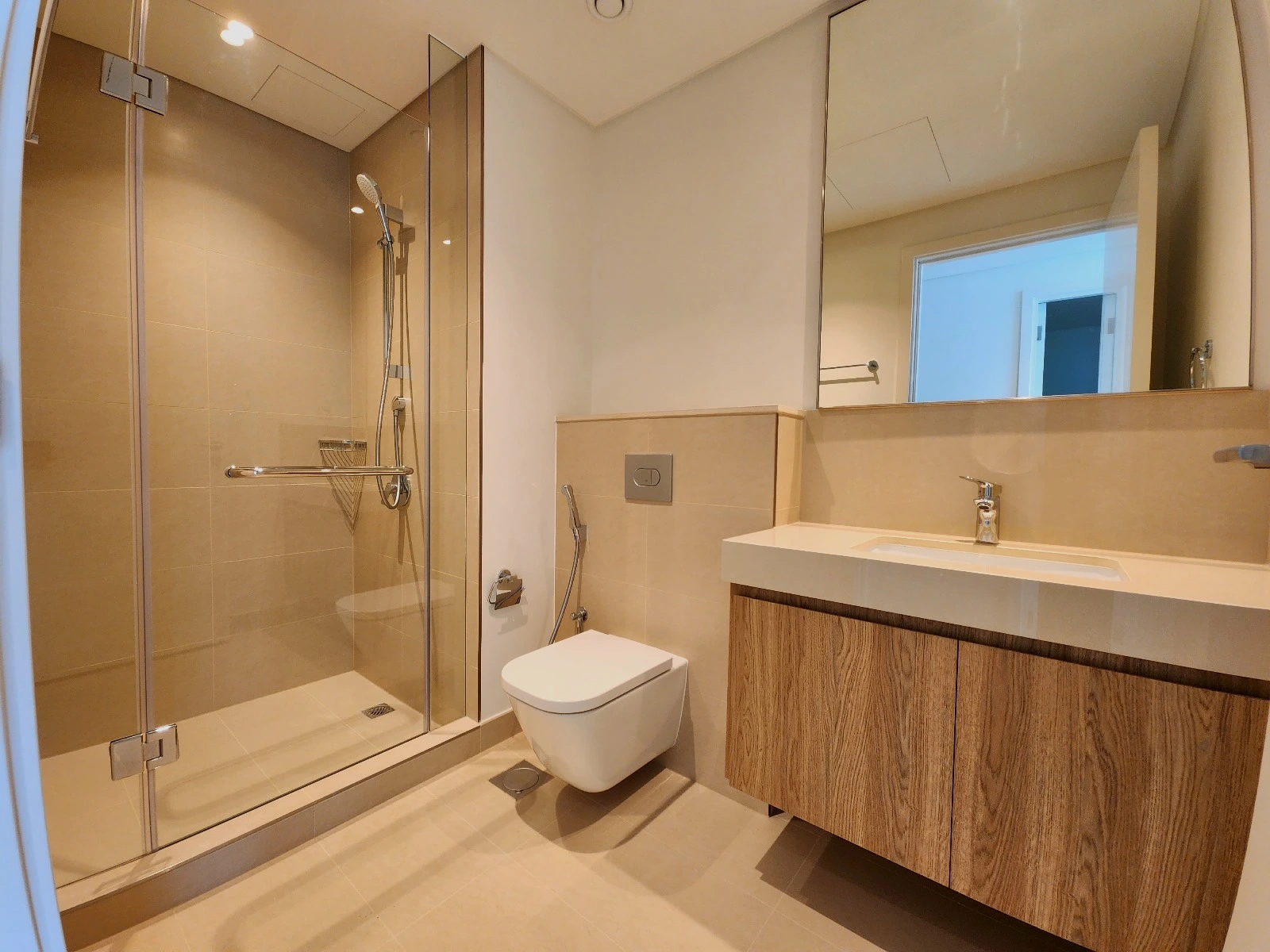Exterior view of Downtown Views II, a modern apartment complex in Dubai, featuring sleek architectural design with glass facades, and an interior shot of a three-bedroom apartment with contemporary decor, large windows, and luxurious finishes.
