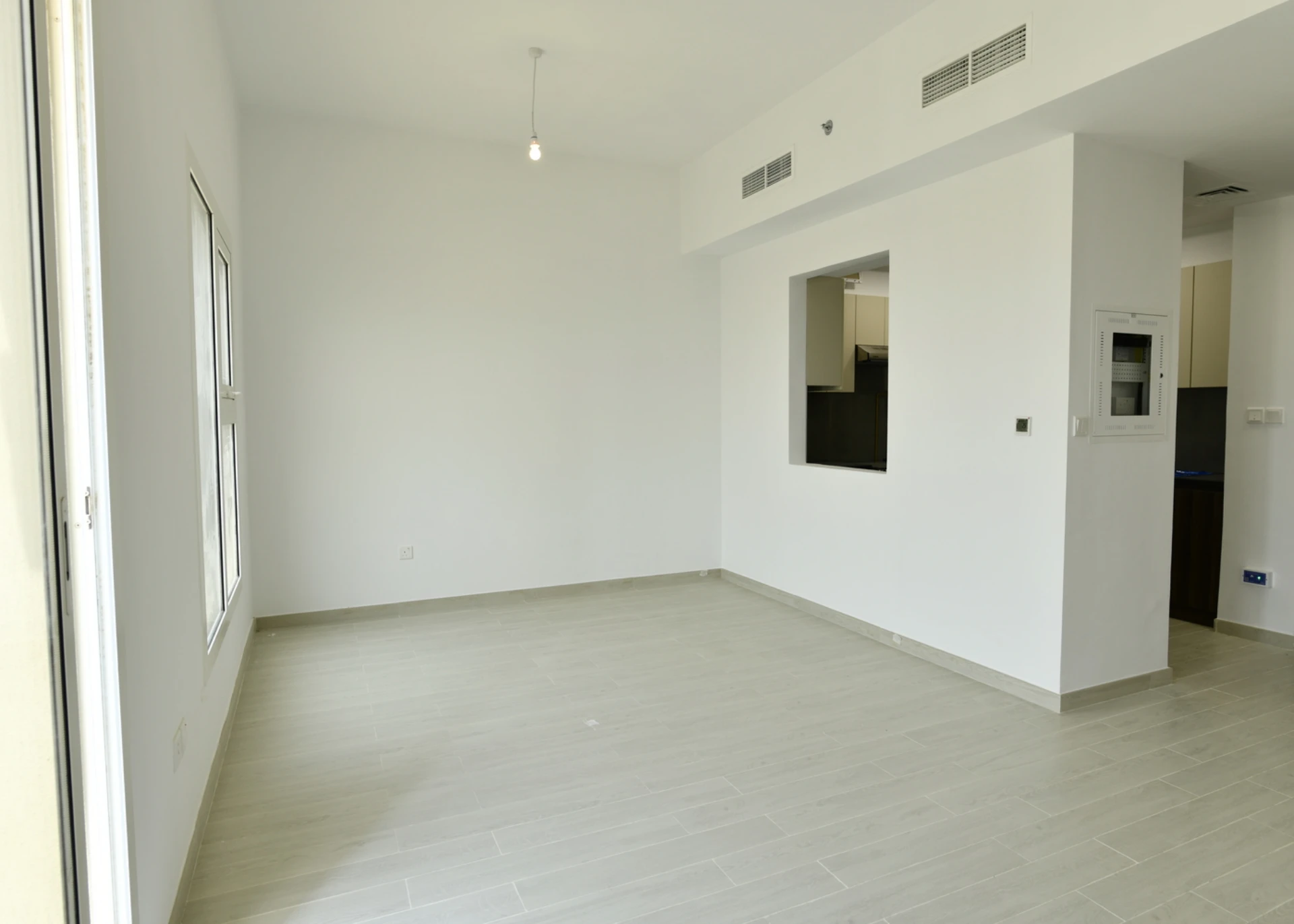 Semi-open kitchen connected to the living room in a 2-bedroom apartment for sale in Al Rimth 13, Remraam, Dubai.